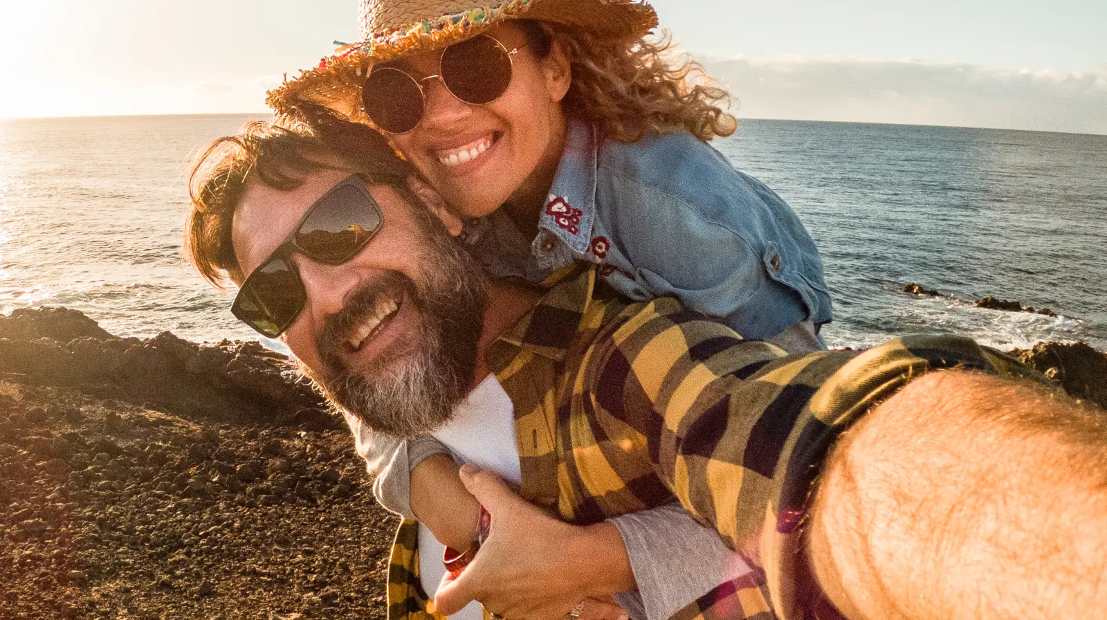A couple smiling by the sea